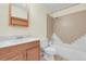Bright bathroom with a framed mirror, updated tile work, and shower over the bath at 2325 S Linden Ct # 206, Denver, CO 80222