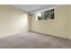 Bedroom with neutral walls, gray carpet, and a bright window at 2325 S Linden Ct # 206, Denver, CO 80222