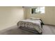 Minimalist bedroom with a queen bed, window and neutral color palette at 2325 S Linden Ct # 206, Denver, CO 80222