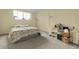 Simple bedroom featuring a bed with floral bedding and a bright window at 2325 S Linden Ct # 206, Denver, CO 80222