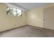 Empty bedroom with neutral walls, gray carpet, and a bright window at 2325 S Linden Ct # 206, Denver, CO 80222