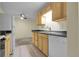 Functional kitchen featuring classic wood cabinets, sleek countertops and dining area at 2325 S Linden Ct # 206, Denver, CO 80222