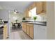 Charming kitchen featuring wood cabinets, black countertops, and a cozy dining area at 2325 S Linden Ct # 206, Denver, CO 80222