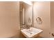 Stylish half bathroom featuring a wall-mounted sink and a modern faucet and neutral tones at 767 Robert St, Longmont, CO 80503