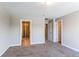 Neutral bedroom with carpet flooring, with a view to the bathroom and hallway at 767 Robert St, Longmont, CO 80503