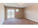 Bright bedroom featuring sliding glass doors, carpet flooring, and expansive views at 767 Robert St, Longmont, CO 80503