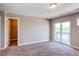Spacious bedroom with carpet, a closet and sliding doors with balcony access at 767 Robert St, Longmont, CO 80503