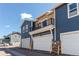 Exterior of blue and tan townhouse with a balcony above the garage at 767 Robert St, Longmont, CO 80503