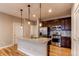 Bright kitchen with stainless steel appliances, granite island, and ample cabinet space at 767 Robert St, Longmont, CO 80503