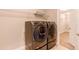 Laundry room with gray front-loading washer and dryer, shelving and a closet at 767 Robert St, Longmont, CO 80503