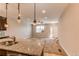 Bright living space connecting to a modern kitchen, featuring a granite countertop island at 767 Robert St, Longmont, CO 80503