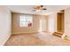 Spacious living room with neutral carpet, natural light, and staircase leading to the next level at 767 Robert St, Longmont, CO 80503