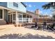 Backyard featuring a fire pit surrounded by chairs, and an enclosed porch at 15962 E Lehigh Cir, Aurora, CO 80013