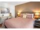 Comfortable bedroom with a writing desk, a queen bed, and a neutral color palette at 15962 E Lehigh Cir, Aurora, CO 80013