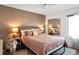 Serene bedroom featuring a queen bed, ample natural light, and a mirrored closet at 15962 E Lehigh Cir, Aurora, CO 80013