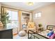 Bright bedroom featuring a cozy reading nook, a comfortable bed, and a large window at 15962 E Lehigh Cir, Aurora, CO 80013