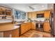 Bright kitchen with wooden cabinets, modern appliances, and a large window offering natural light at 15962 E Lehigh Cir, Aurora, CO 80013