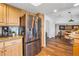 Kitchen featuring stainless steel appliances, wooden cabinets, and an open design leading to the breakfast nook at 15962 E Lehigh Cir, Aurora, CO 80013