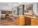 Modern kitchen showcasing wooden cabinets, stainless steel dishwasher, and breakfast nook in an open layout at 15962 E Lehigh Cir, Aurora, CO 80013