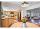 Kitchen featuring wooden cabinets, modern appliances, and open access to the living and dining areas at 15962 E Lehigh Cir, Aurora, CO 80013