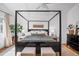 Spacious main bedroom with a large four-poster bed, plush bedding, and elegant decor at 15962 E Lehigh Cir, Aurora, CO 80013