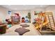 Spacious playroom with plush carpet, toys, and natural light from a basement window at 15962 E Lehigh Cir, Aurora, CO 80013