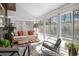 Bright sunroom filled with natural light, featuring cozy seating, stylish decor and views of the backyard at 15962 E Lehigh Cir, Aurora, CO 80013