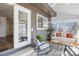 Cozy sunroom with ample seating, wood tables, decorative pillows and access to the backyard at 15962 E Lehigh Cir, Aurora, CO 80013