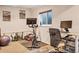 Workout area with stationary bike, yoga mats, exercise ball, desk with computer and natural light from a window at 15962 E Lehigh Cir, Aurora, CO 80013