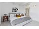 Bright bedroom features white walls and ceiling beams with stylish decor and gray carpet at 1441 N Humboldt St # 505, Denver, CO 80218