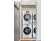 Laundry closet features a stacked washer and dryer with mirrored closet doors at 1441 N Humboldt St # 505, Denver, CO 80218