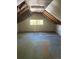 The attic has a window and some exposed wood at 4536 Beach Ct, Denver, CO 80211