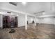 Spacious basement with wood-look flooring, white support columns, and ample potential for customization at 4536 Beach Ct, Denver, CO 80211