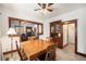 Traditional dining room featuring wood trim, classic built-in cabinet, and adjacent living area at 4536 Beach Ct, Denver, CO 80211