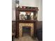 A wood fireplace with mantel that has various items on top at 4536 Beach Ct, Denver, CO 80211