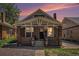 Charming brick home featuring a cozy front porch with white support beams, showcasing classic architectural details at 4536 Beach Ct, Denver, CO 80211