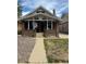 Charming brick home with a covered porch, walkway, and landscaping at 4536 Beach Ct, Denver, CO 80211
