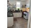 This kitchen has white cabinets, shelves, and a gas oven at 4536 Beach Ct, Denver, CO 80211