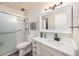Clean and updated bathroom with a glass-enclosed shower, modern vanity, and brushed nickel fixtures at 650 S Clinton St # 6D, Denver, CO 80247