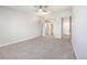 Spacious carpeted bedroom with ceiling fan and access to bathroom at 650 S Clinton St # 6D, Denver, CO 80247