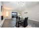 Elegant dining area with a glass table, black chairs, and sliding glass doors to the balcony at 650 S Clinton St # 6D, Denver, CO 80247