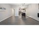 Open concept dining area with modern light fixture and view of kitchen at 650 S Clinton St # 6D, Denver, CO 80247