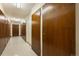 Hallway with multiple wooden doors and white tile floors for extra storage at 650 S Clinton St # 6D, Denver, CO 80247