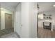 Hallway view of front door and kitchen with stainless steel appliances and white cabinets at 650 S Clinton St # 6D, Denver, CO 80247