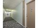 Well-lit hallway with patterned carpet leading to individual units in the building at 650 S Clinton St # 6D, Denver, CO 80247