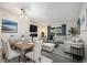 Open living and dining area featuring new light fixture, furniture, and neutral paint colors at 650 S Clinton St # 6D, Denver, CO 80247