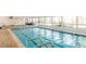 Indoor swimming pool with wide windows and a place to relax on lounge chairs at 650 S Clinton St # 6D, Denver, CO 80247