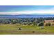 Breathtaking view of a golf course community with rolling hills and mountain backdrop at 21950 E Crestline Ln, Aurora, CO 80015