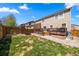 Grassy backyard with wooden fence and wooden deck at 21950 E Crestline Ln, Aurora, CO 80015