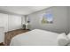 Bright bedroom with hardwood floors, two windows, and a closet for ample storage at 21950 E Crestline Ln, Aurora, CO 80015